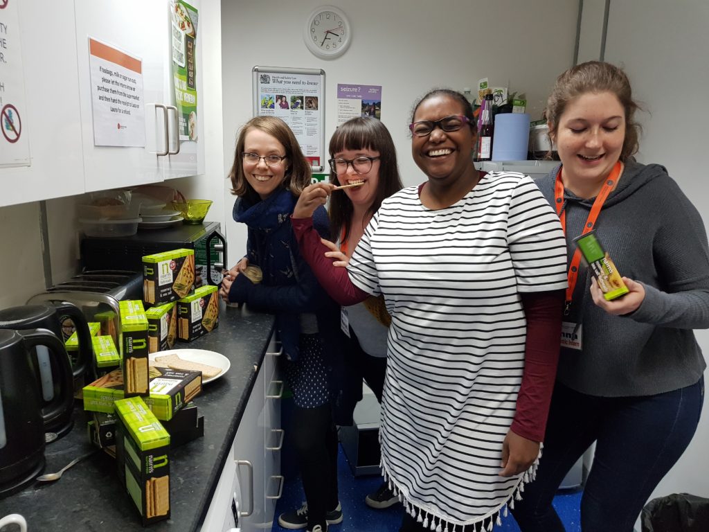 Nairns in an office with women happily sampling
