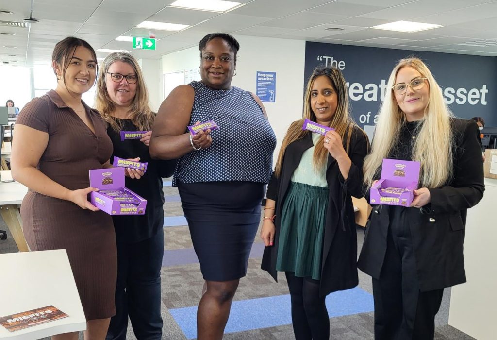 Misfits Office Sampling displaying several women enjoying their bar in an office