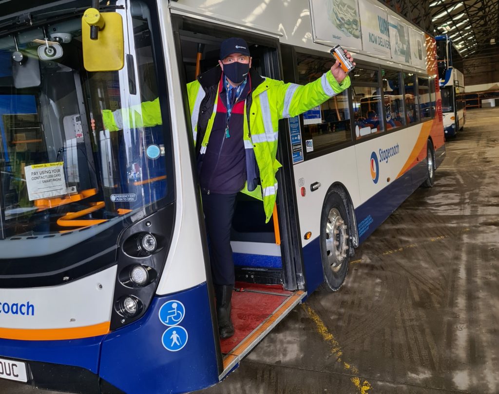 Happy bus driver displaying his sample as part of Key Worker Sampling