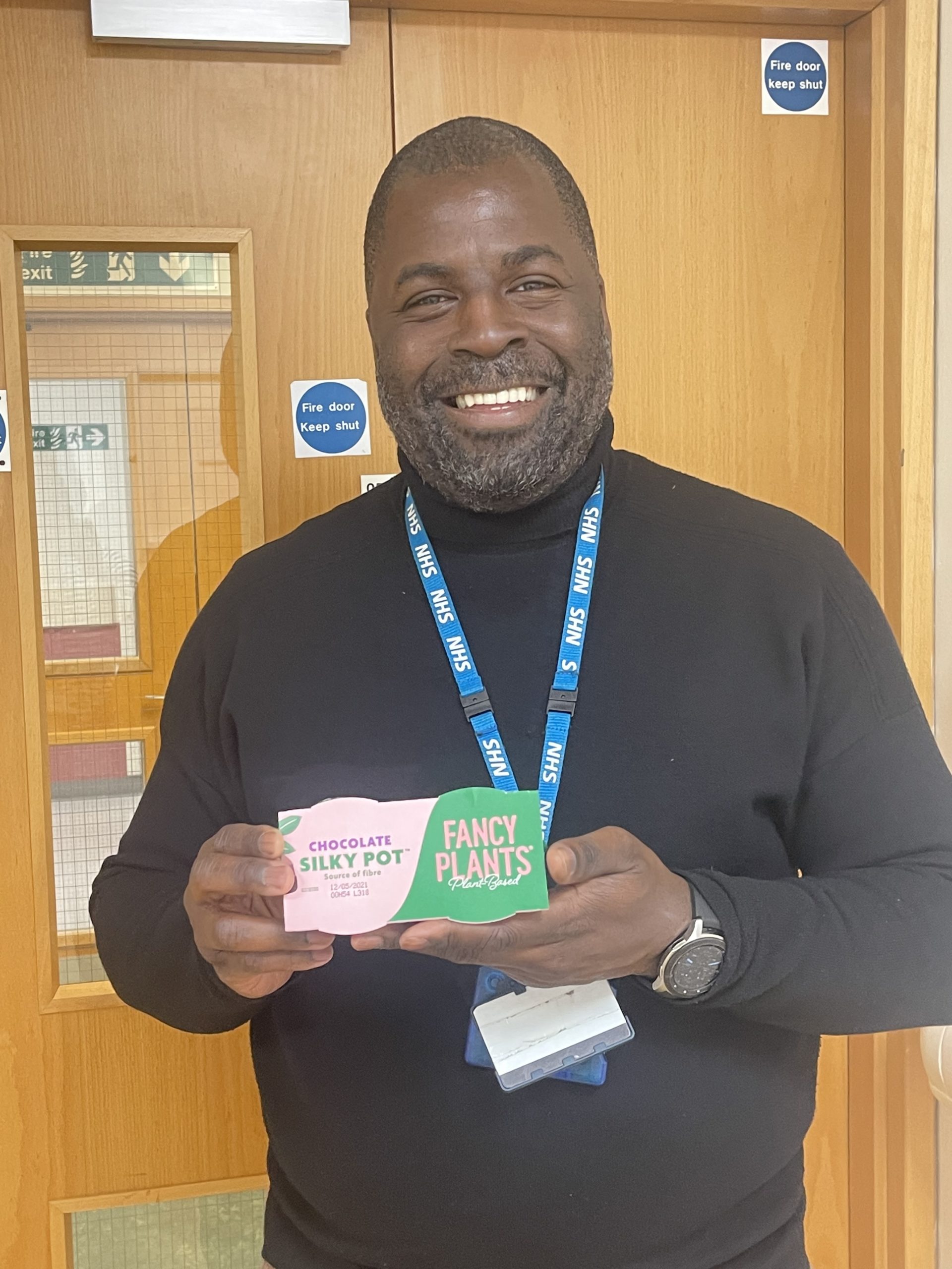 NHS Sampling showing a happy man holding Fancy Plants